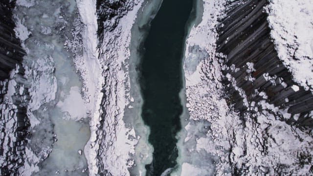 Snow-covered canyon with a frozen river