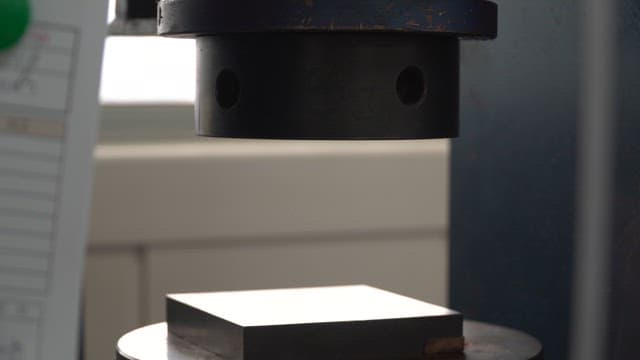 Machine pressing a metal object