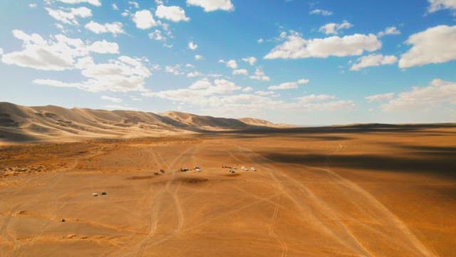 Expansive Desert Dunes Under a Cloudy Sky