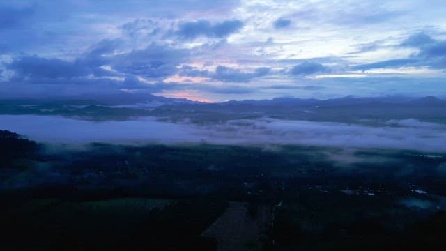 Misty mountains at dawn with a colorful sky