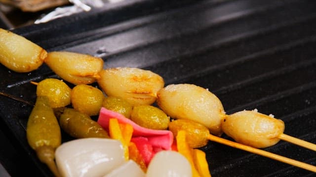 Grilled golden brown garlic and ginkgo nut skewers