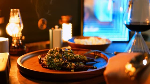 Elegant meal with lamb steak and wine on a wooden table
