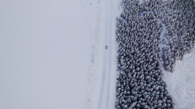 Car driving through a snowy landscape