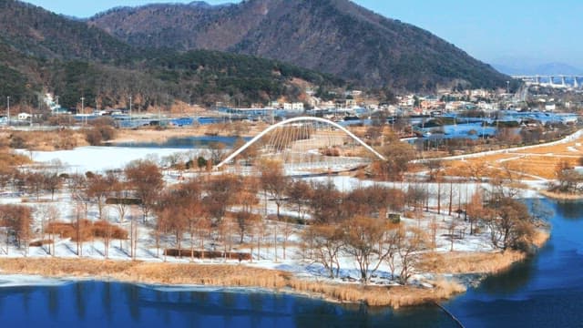 Winter View of Snowy Park and River Near Town