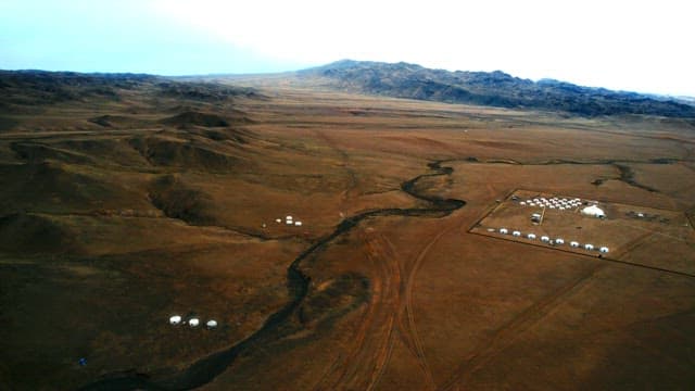 Aerial View of a Distant Landscape with Tents