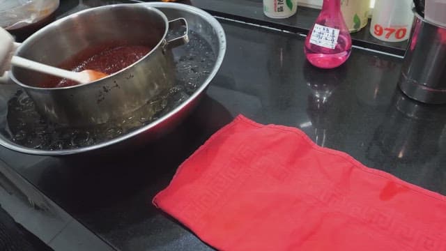 Cooking sauce in a pot cooled with an ice bath