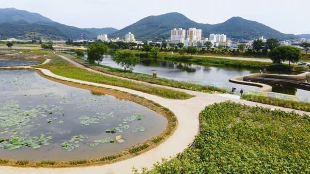 Scenic lake with mountains and city buildings