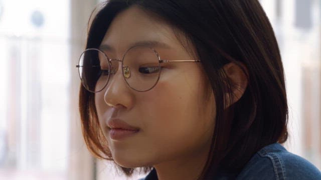 Woman wearing glasses concentrating on something