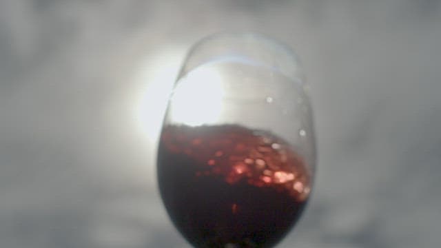 Swirling Red Wine in Transparent Glass