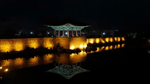 Illuminated traditional pavilion at night