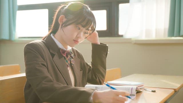 Student stretching while studying in classroom