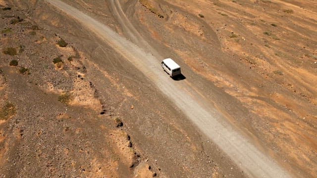 Van traveling on a remote dirt road