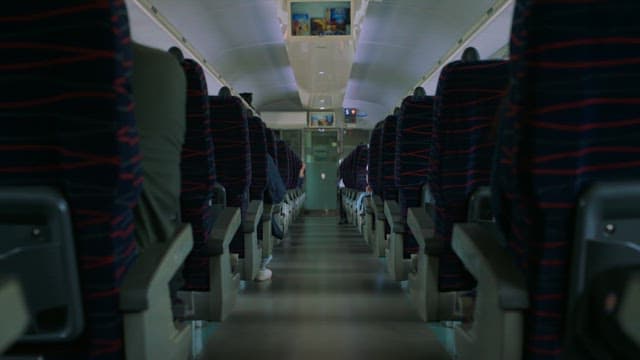 Aisle of a train with passengers on board