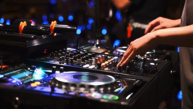 DJ mixing music in a lively nightclub