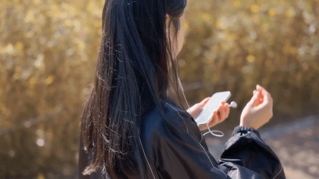 Woman listening to music outdoors