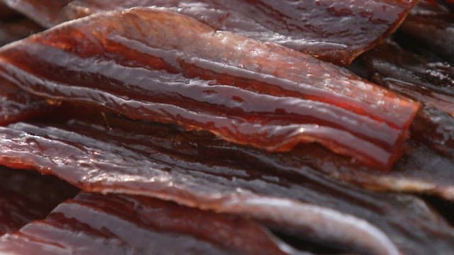 Glossy surface of neatly stacked fresh half-dried saury