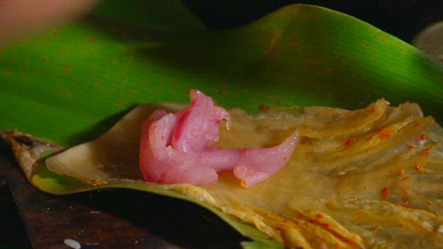 Tuna plated on banana leaves and kimchi