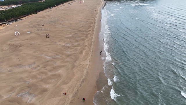 Vast sandy beach with gentle waves