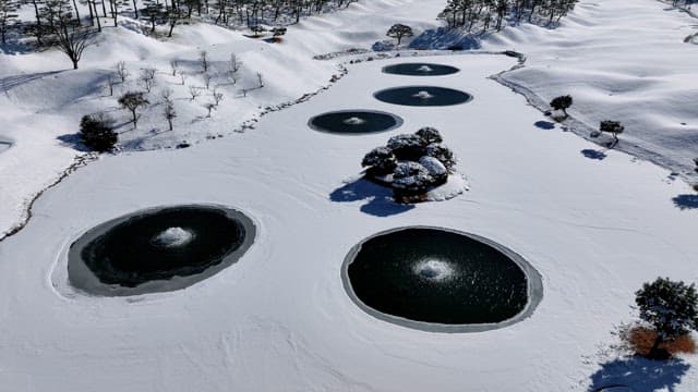 Snow-covered Landscape with Serene Ponds