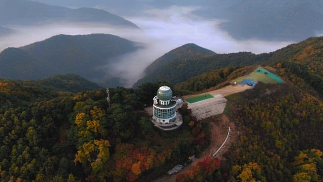Observatory Overlooking a Misty Mountain Range