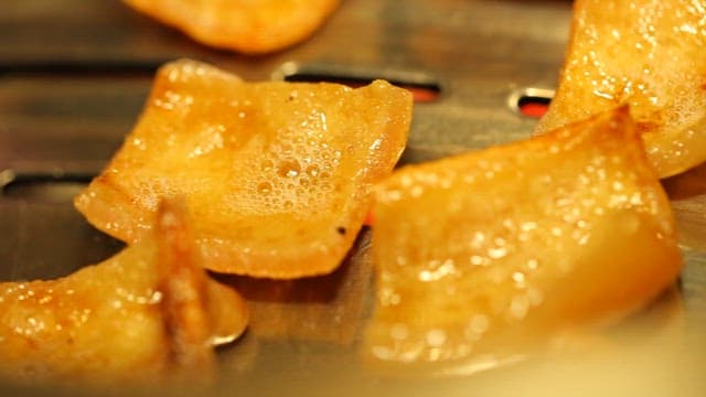 Pork rinds grilled over a grill