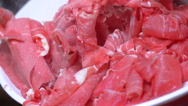 Beef Being Poured into Boiling Soup