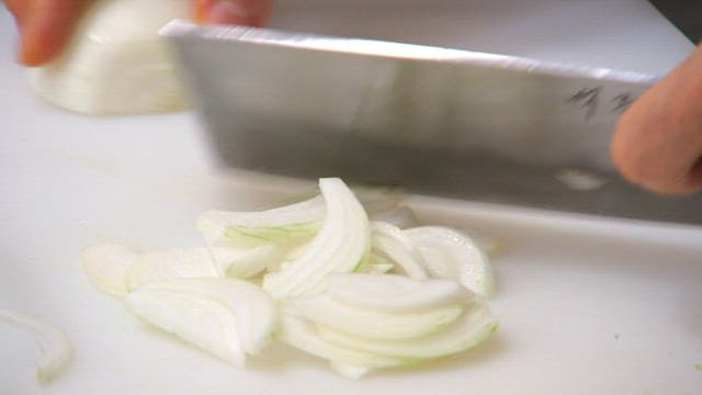 Slicing onions on a cutting board