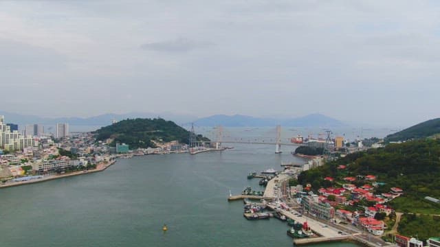 Coastal city with a bridge and mountains