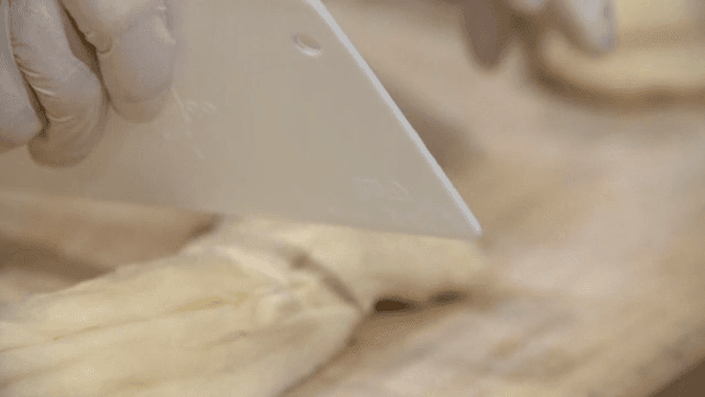 Dough being prepared and cut by hand