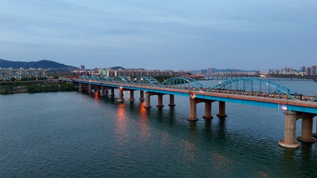 Bridge over a river with city skyline