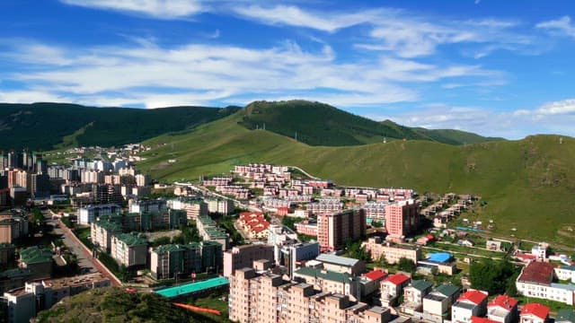 Cityscape with green hills in the background