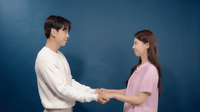 Couple holding hands and smiling indoors