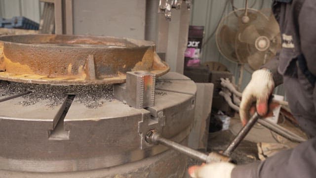 Worker operating a metal machine