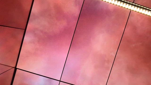 Ceiling digital screens displaying colorful sky scenes