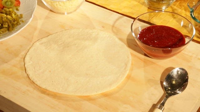 Spread Tomato Sauce on Tortilla Dough