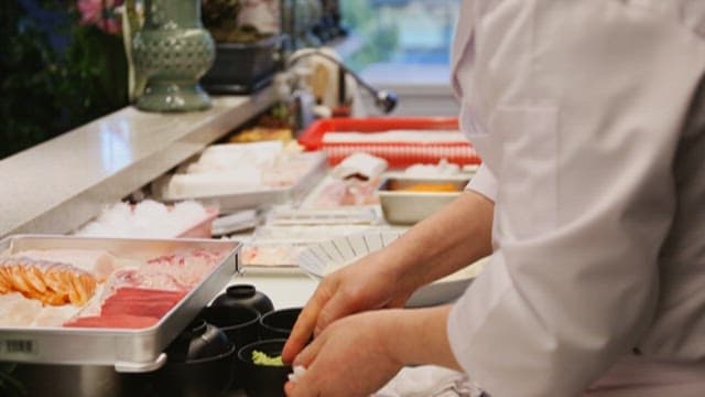 Chef Preparing Sushi in a Professional Kitchen