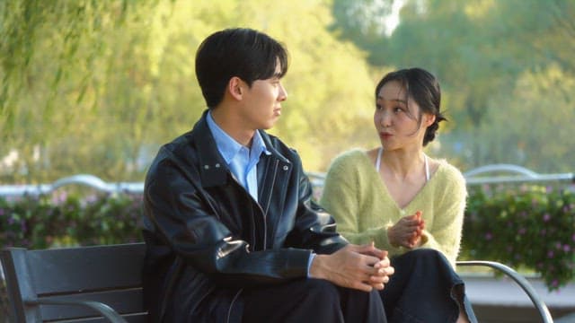 Couple having a conversation on a park bench