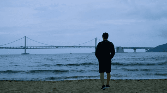 Man on the Beach of Busan and Looking at the Waves