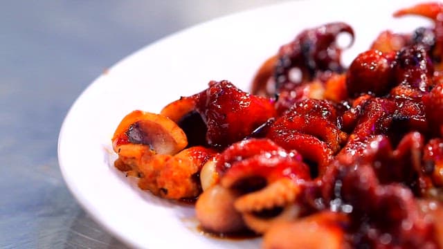 Spicy grilled webfoot octopus on a plate