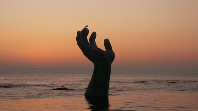 Pohang Homigot, hand sculpture on the beach at sunset