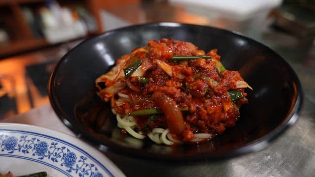 Noodle Dish Topped with Spicy Stir-fry Sauce