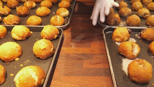 Packing freshly-baked bread into a box on a wooden table