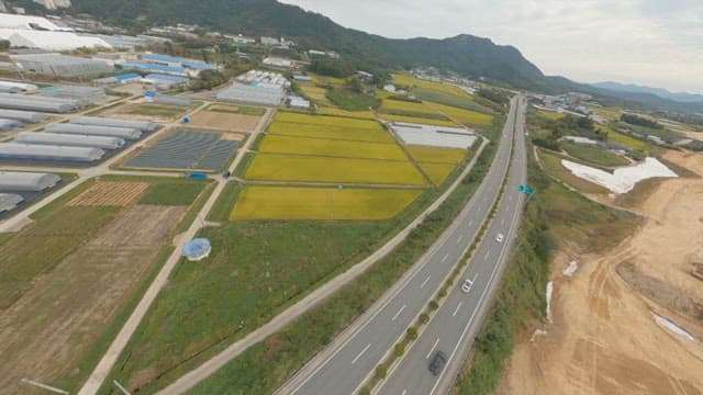Expansive and lush farmland next to a highway