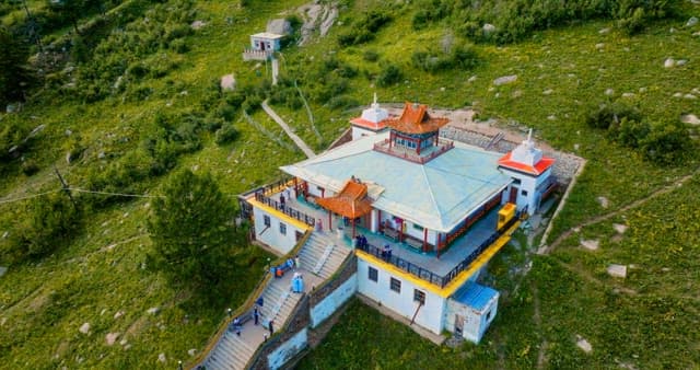 Temple on a hillside with lush greenery