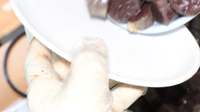 Transferring freshly cooked sundae to a plate in the kitchen