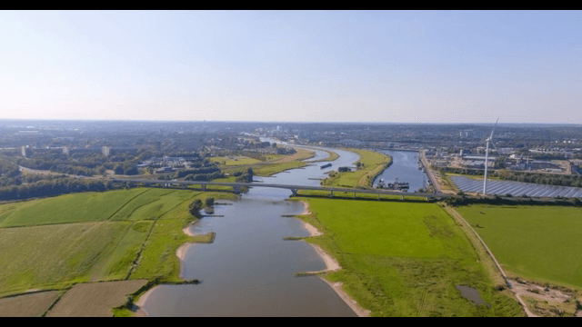 River flowing through a green field