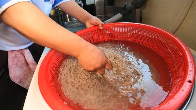 Preparing Noodles in a Kitchen