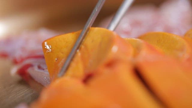 Fresh liver of fish picked up with chopsticks