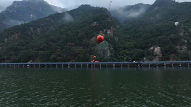 Cloudy Lake View with Passing Train and Mountains