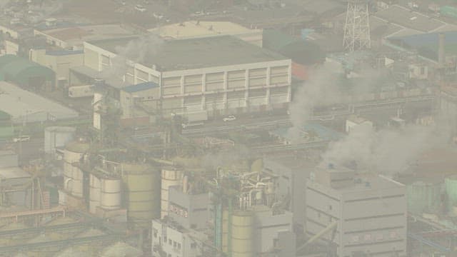 Aerial View of Industrial Complex with Smoke